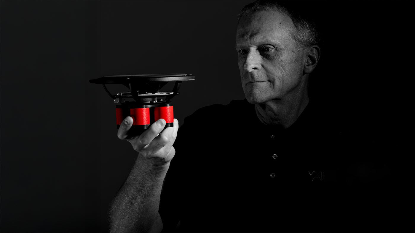 A Wilson Audio team member holding an Autobiography driver, its magnet assembly picked out in red