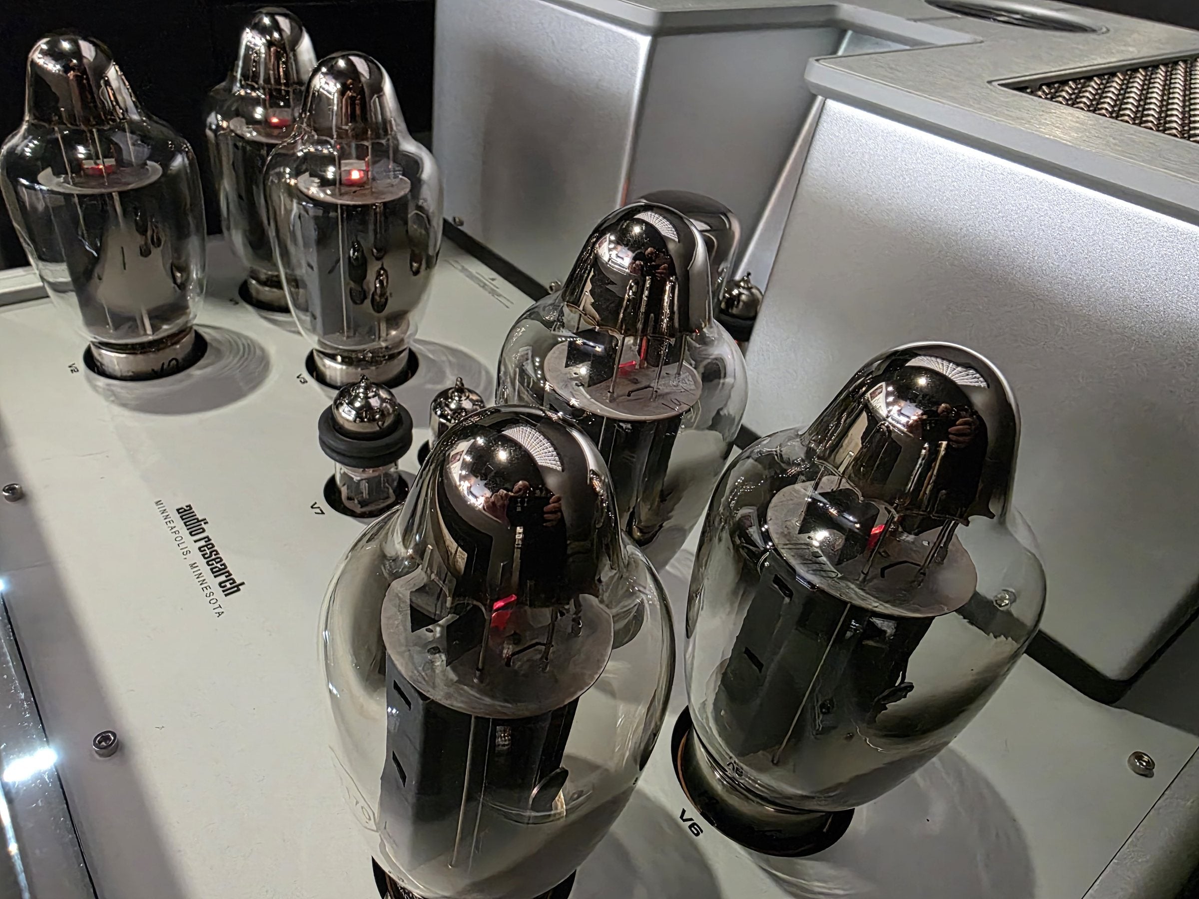 Close-up of the glowing output tubes on an Audio Research valve amplifier in the Sound Sanctuary Austin showroom.