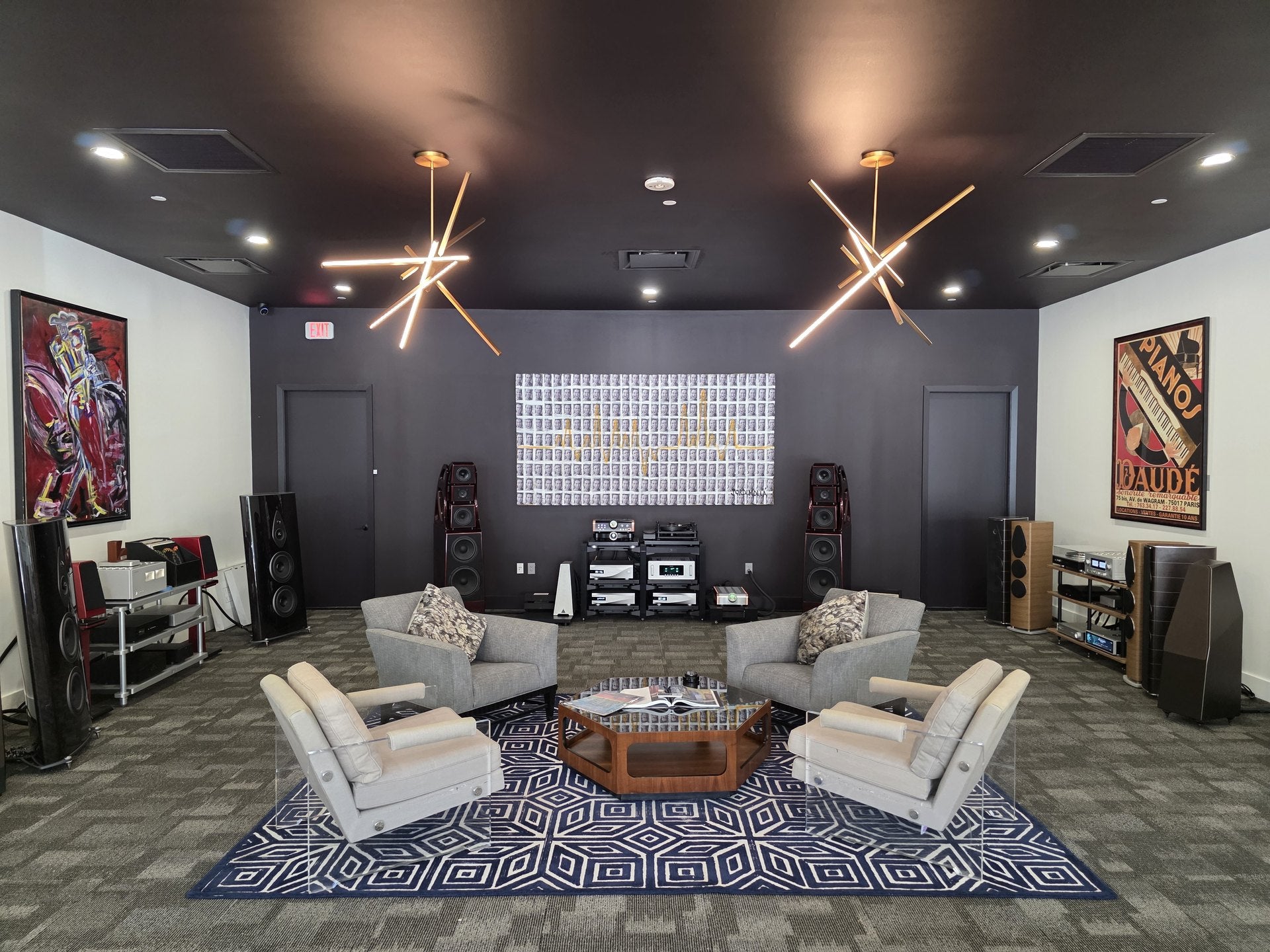 The listening room at Sound Sanctuary Austin: four armchairs at the listening position, high-end loudspeakers along both walls, and the electronics racks and turntable centred on the back wall.